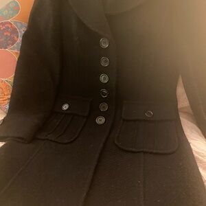 Buttoned down black coat. Very stylish and unique